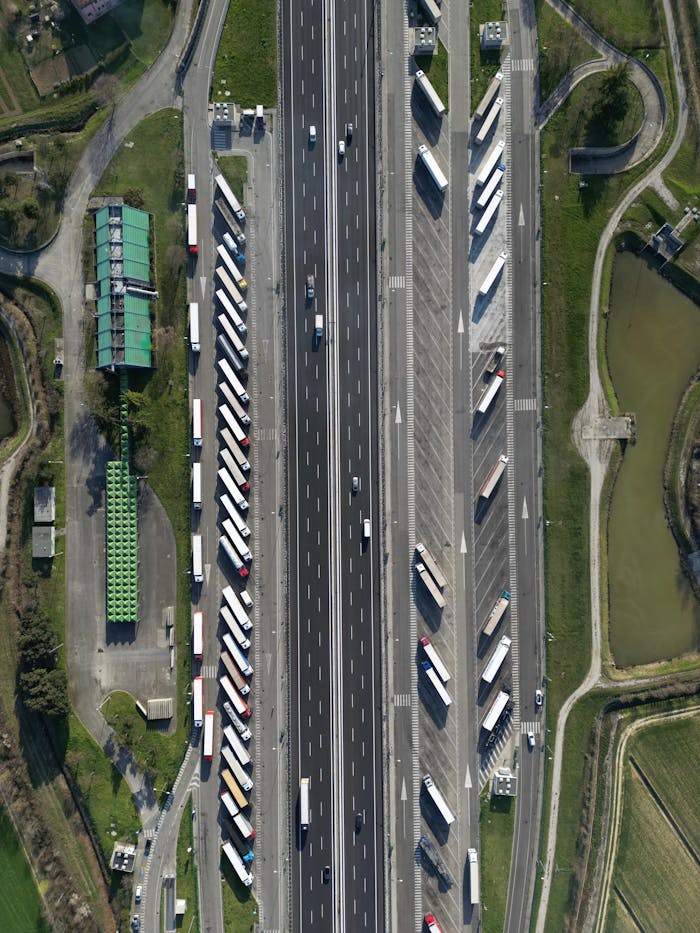 creative-03 Highway traffic captured from above showcasing trucks and parked vehicles in Roncade, Italy.